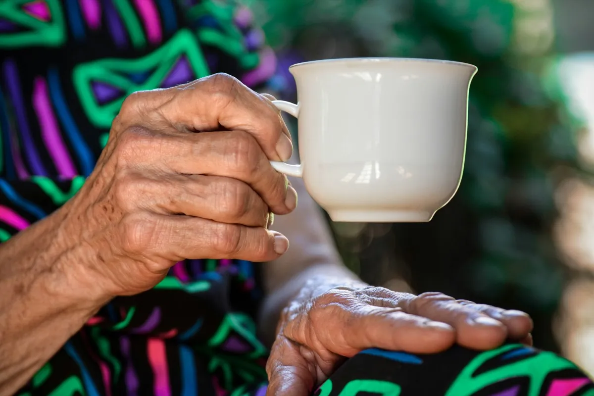 Elderly person enjoying tea at home